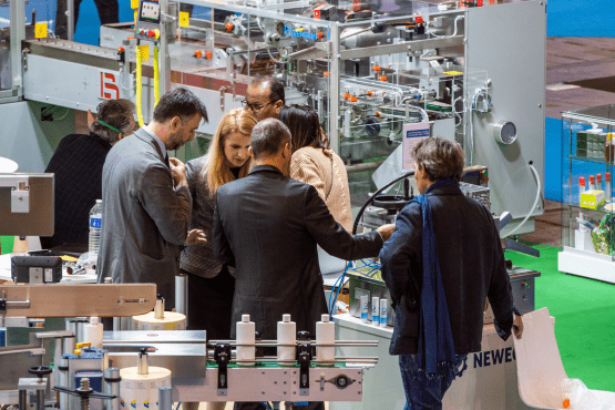 a group of visitors at a booth